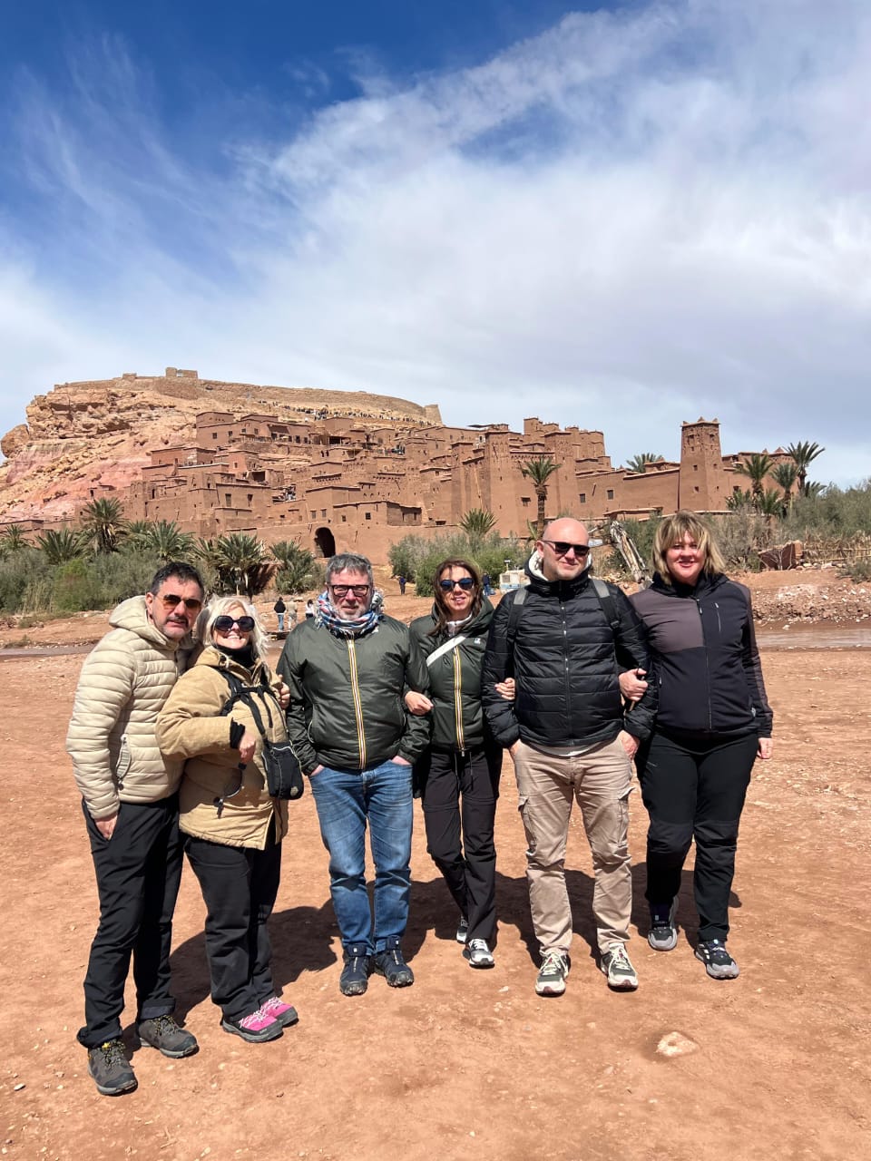 Travelers in front of Kasbah Ait Ben Haddou, a UNESCO World Heritage site
