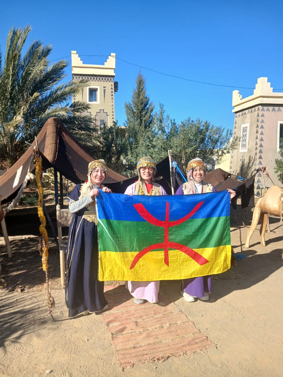 Travelers in traditional Amazigh dress welcomed at the Merzouga desert camp